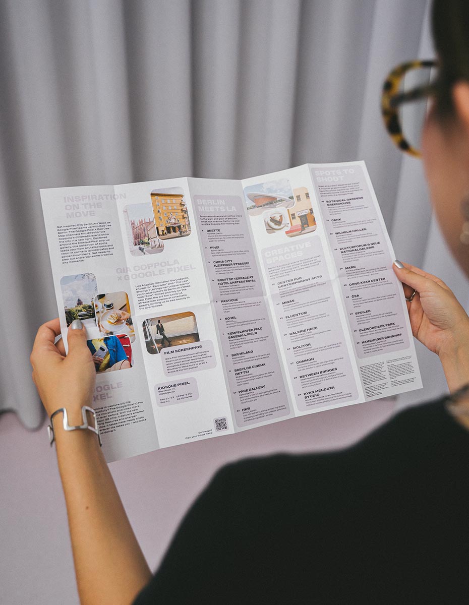 Close-up of a person reading an art map, produced by a Design Agency specializing in UX Design and Editorial Content.