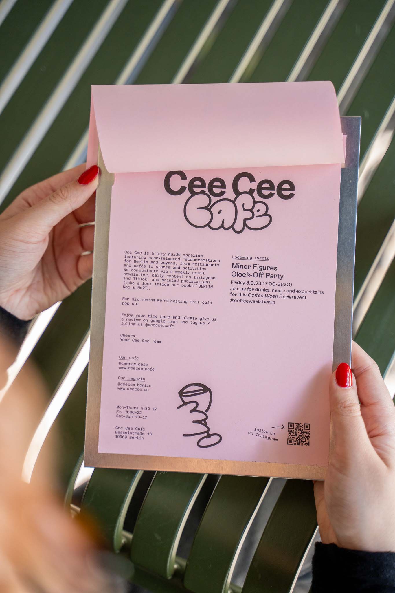 Hand holding Cee Cee Café menu, photographed for Content Creation and Social Media Content.