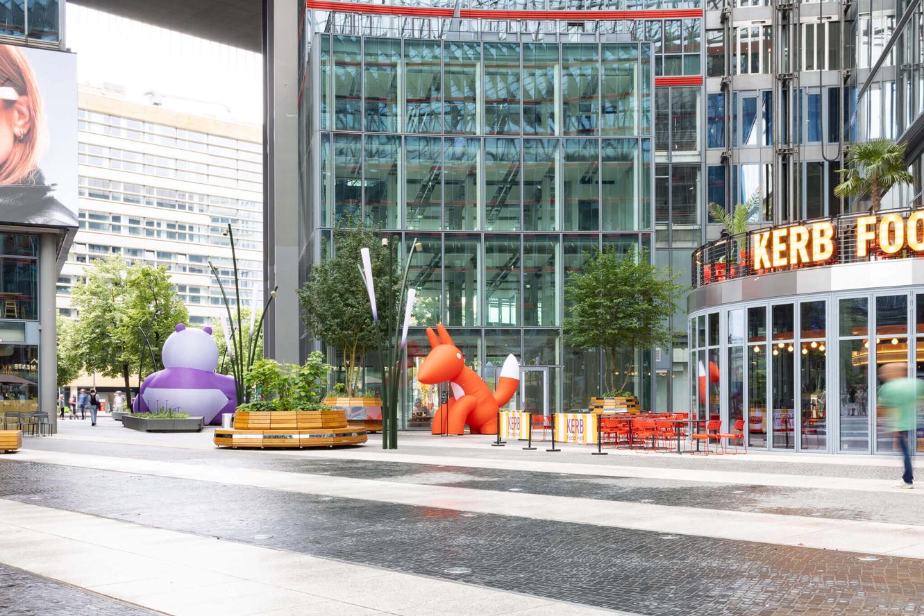 Inflatable purple and red characters across a public plaza, created for an Event Design and Brand Experience.