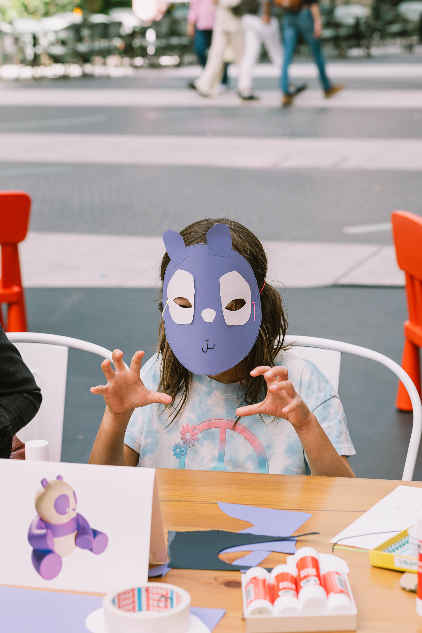 Child wearing a handmade animal mask during a Creative Agency’s Event Design workshop.