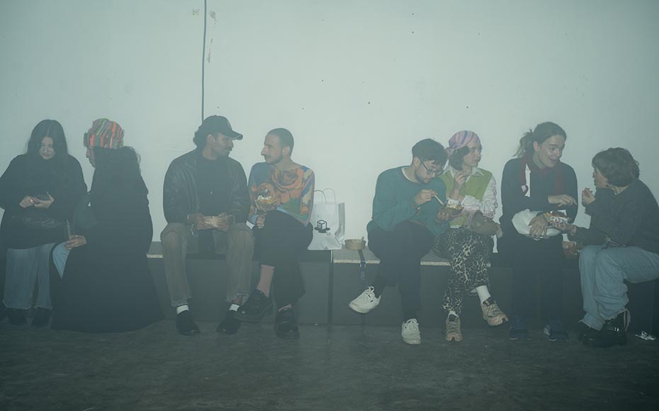 Guests sitting along a bench in a foggy room, eating and chatting during the Oatly Matcha launch, documented by a content agency in Berlin.