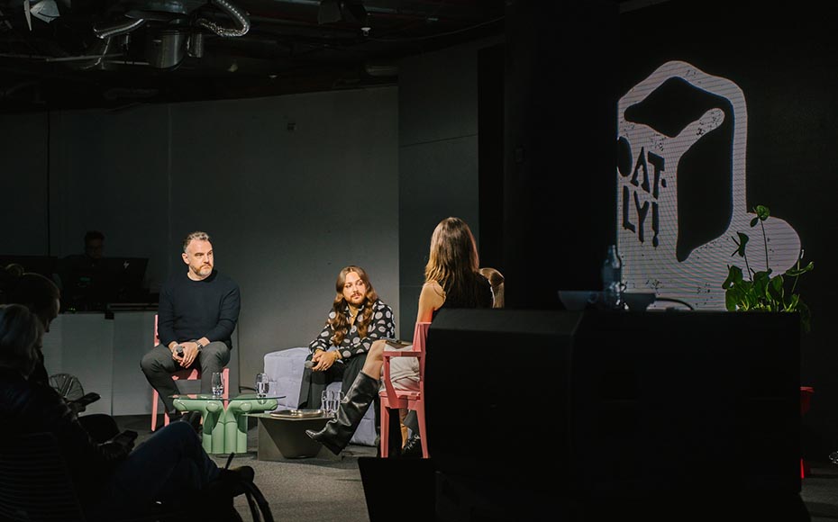 A panel discussion on stage with Oatly branding during the Matcha product launch, photographed by a creative marketing agency and design agency in Berlin.