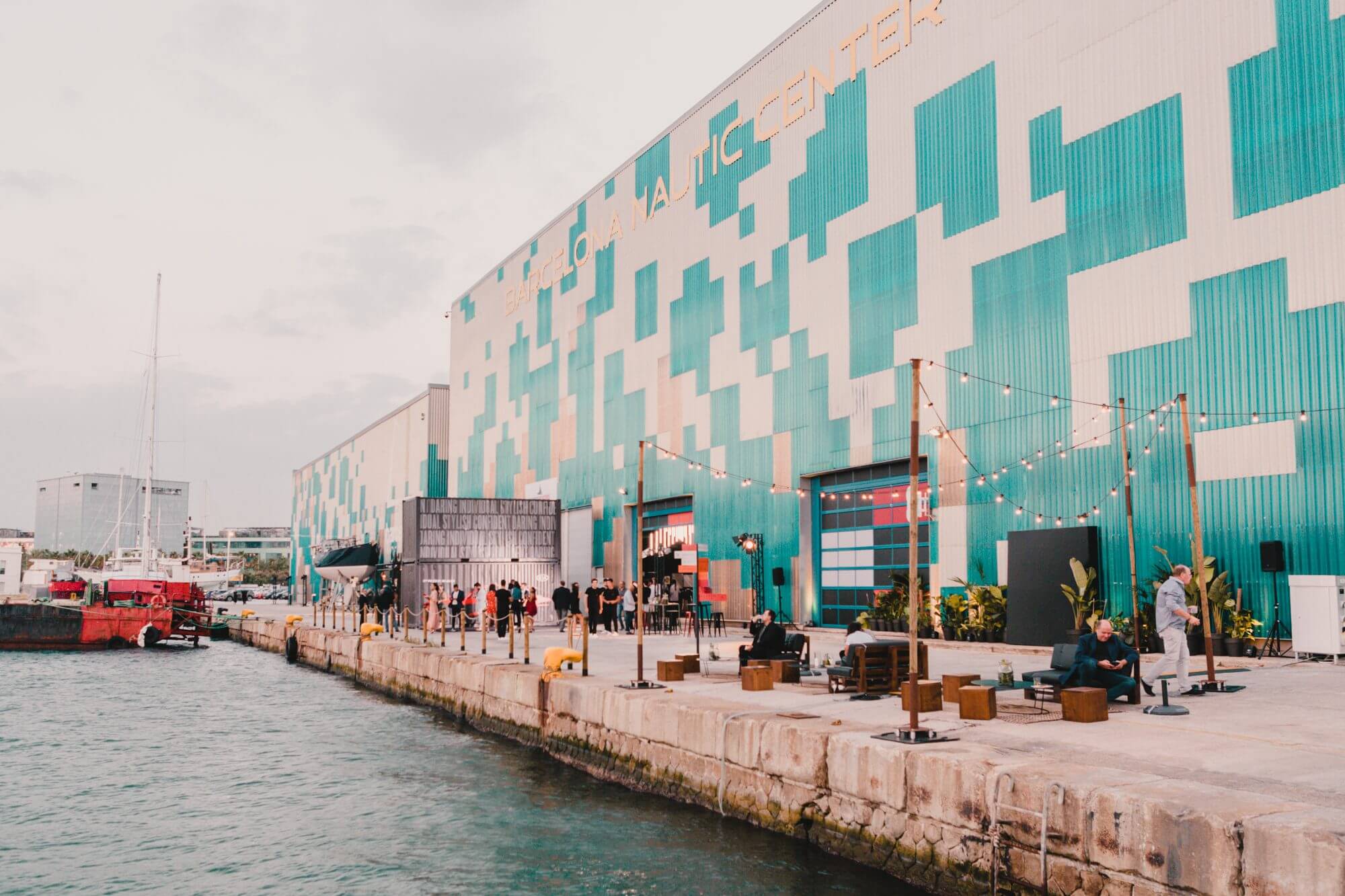 A photograph of the KIA launch event design at a harbor in Barcelona.