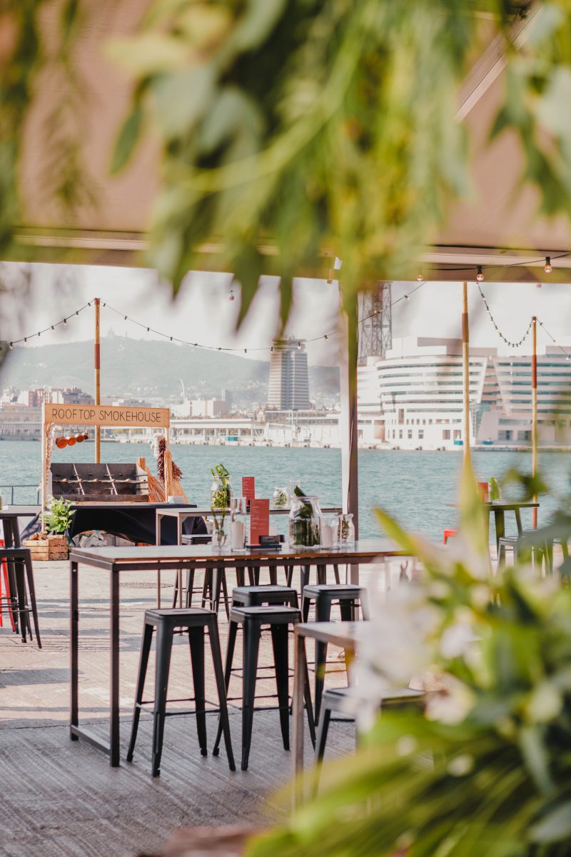 A photograph of the KIA launch event design at a harbor in Barcelona, showing a food bar.