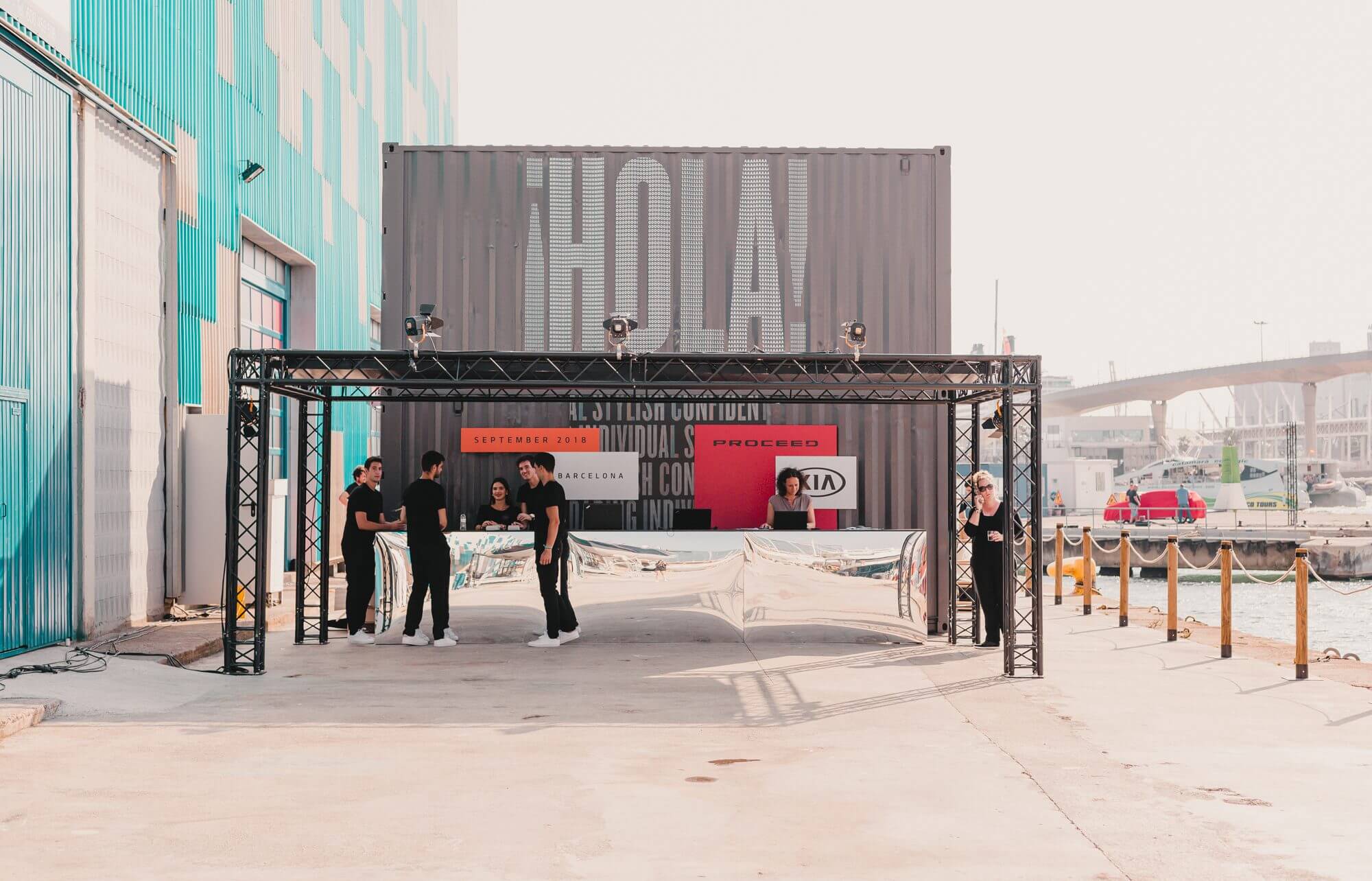 An image of the KIA launch event welcome desk, showing the graohic design and branding for the event.