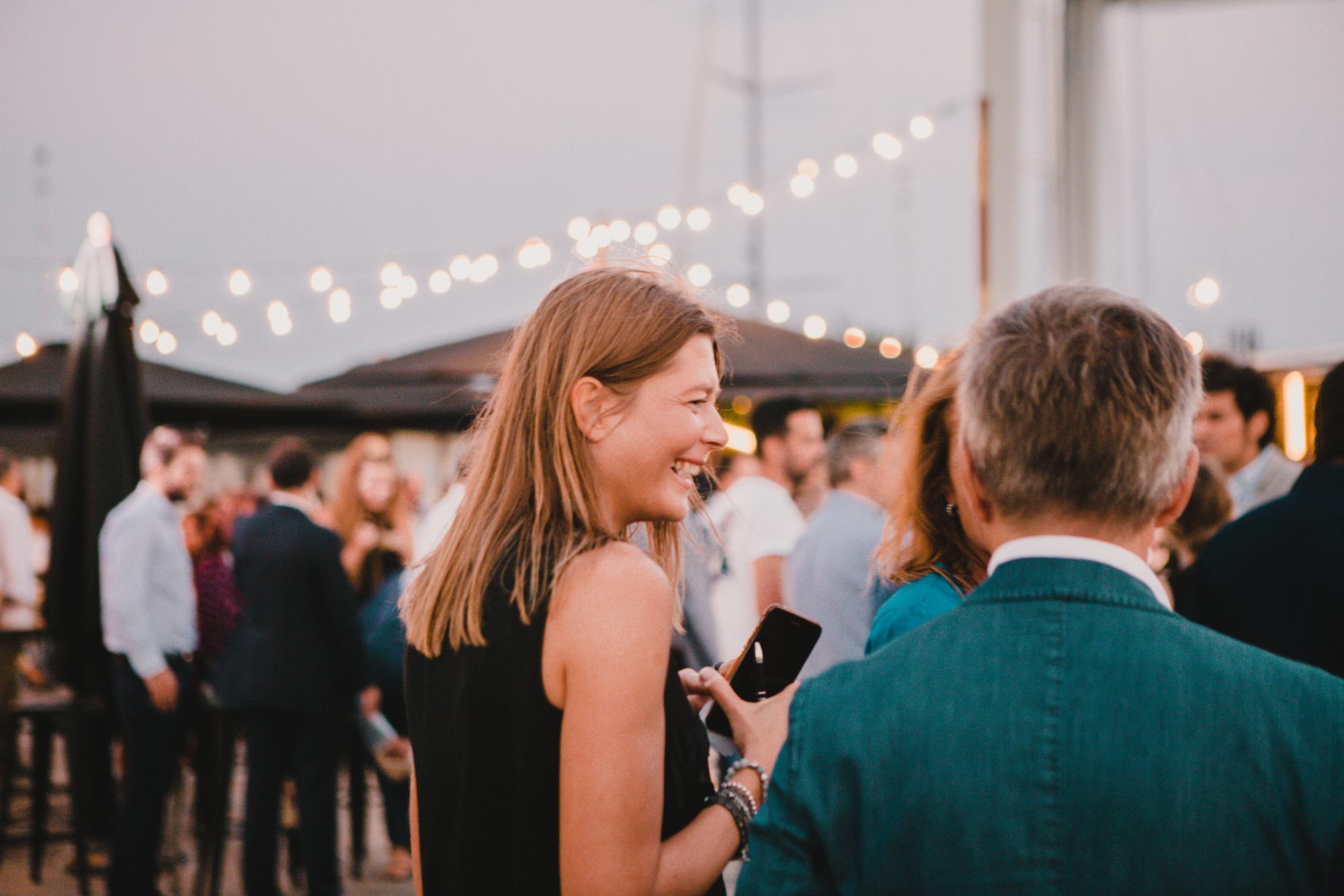 A photograph of a woman smiling at the KIA launch event.