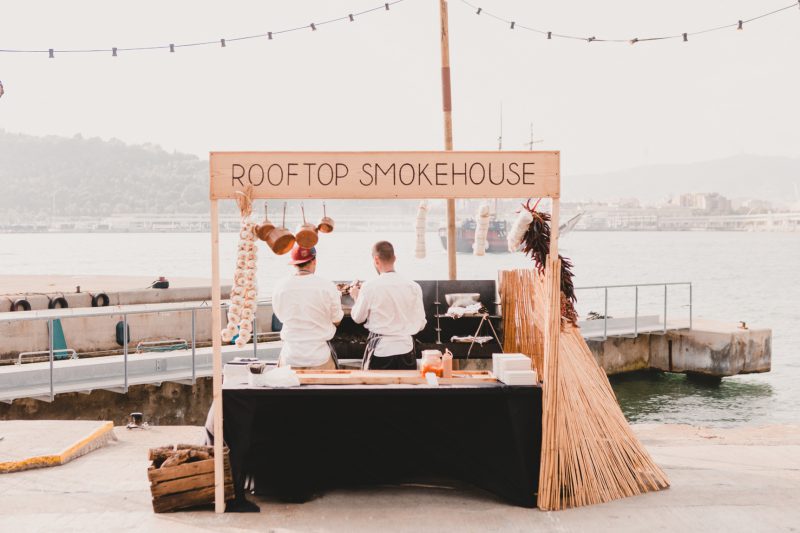 An image of a "rooftop smokehouse" food stand at the KIA launch event.