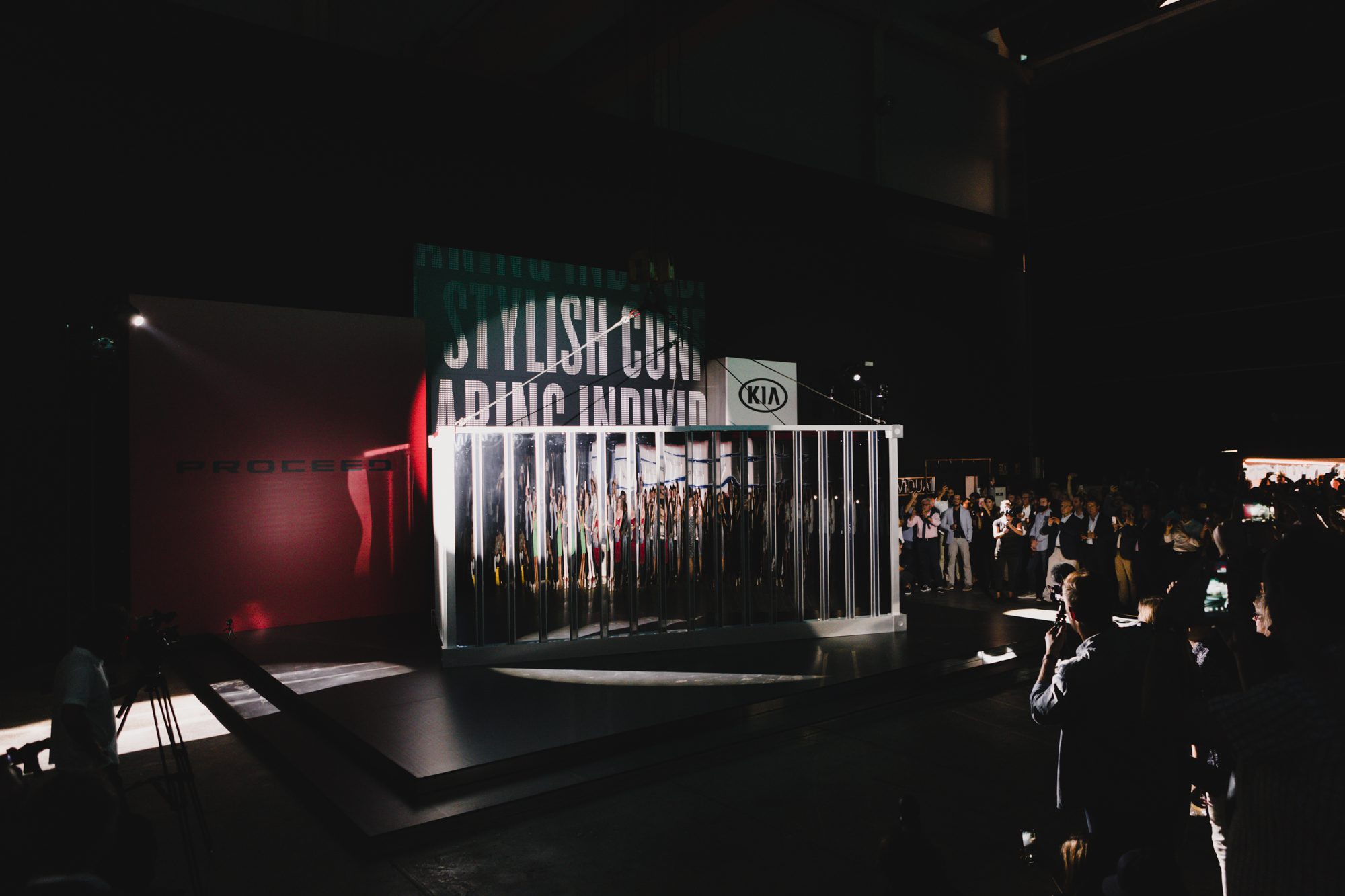 An image of the reveal of the new KIA Proceed car, where a container is being lifted to reveal the new car.