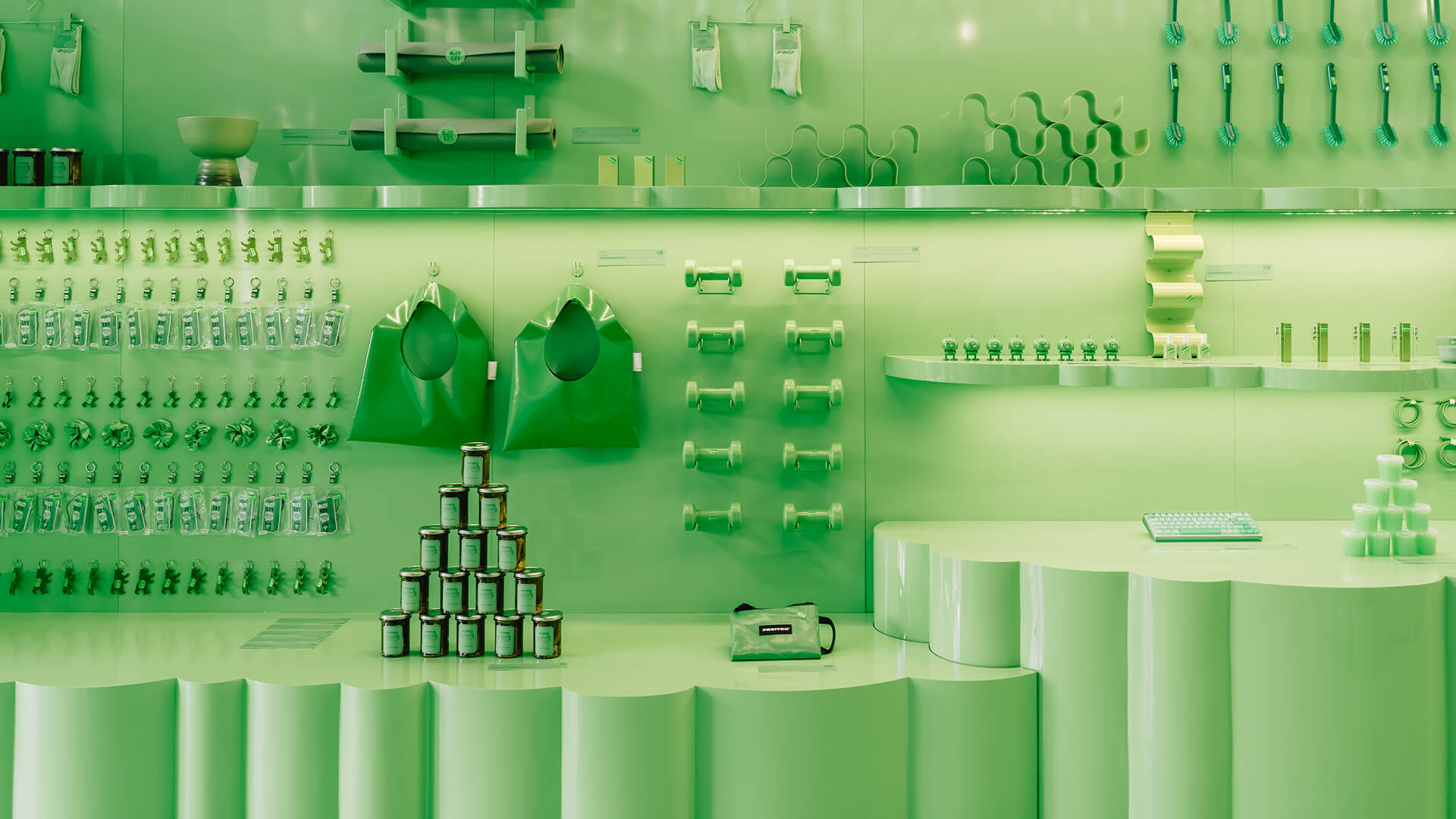 Merchandise wall at the Oatly Monochrome pop-up – branding and product curation for brand experience