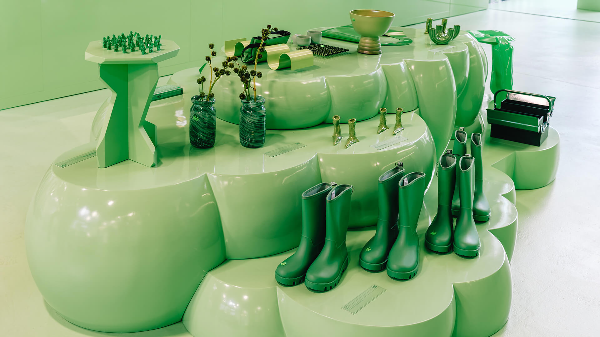 Product display with rubber boots and merchandise – content agency styling for Oatly Monochrome
