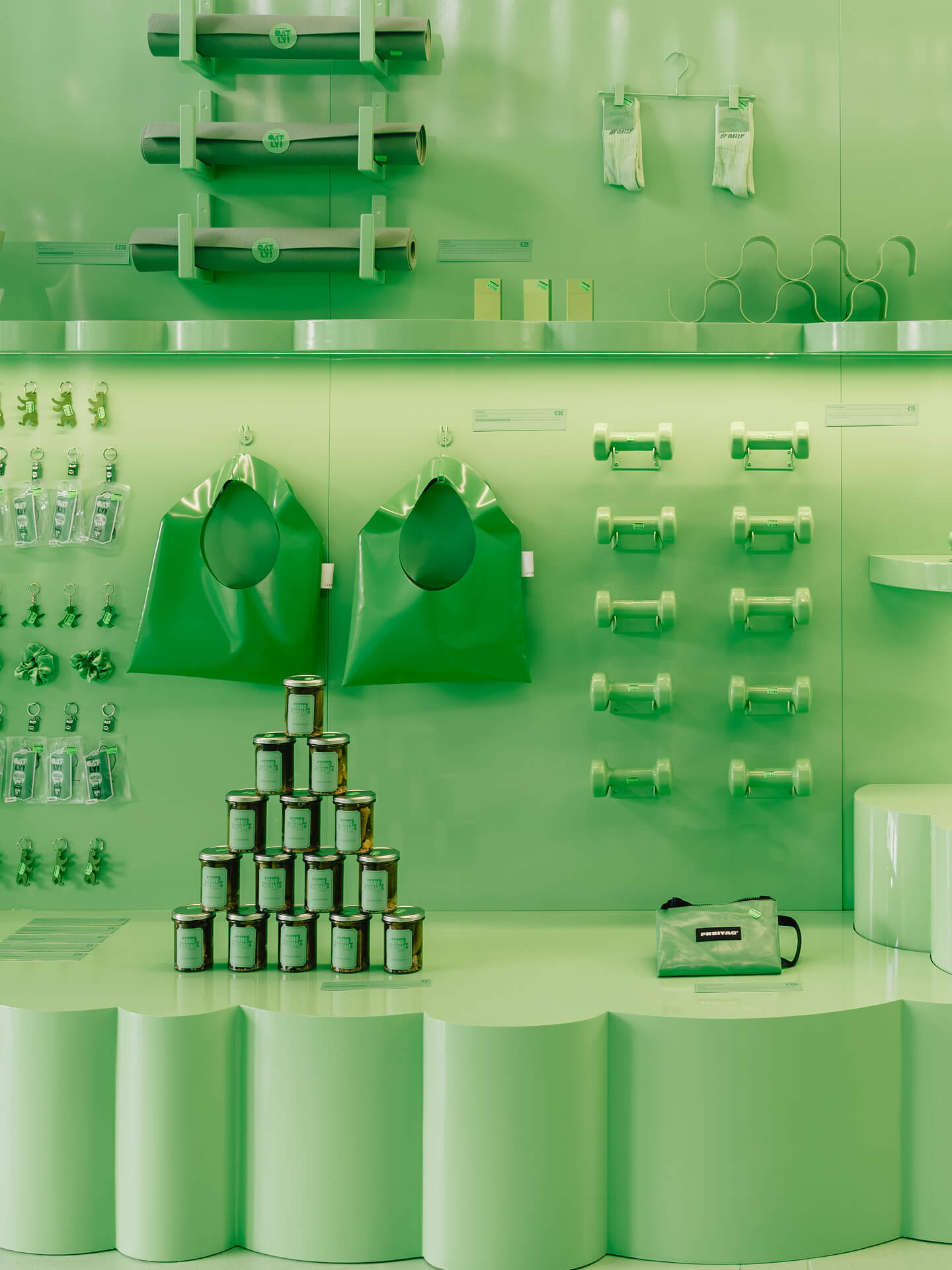 Retail wall featuring yoga mats, socks and merchandise – brand experience design for the Oatly pop-up store