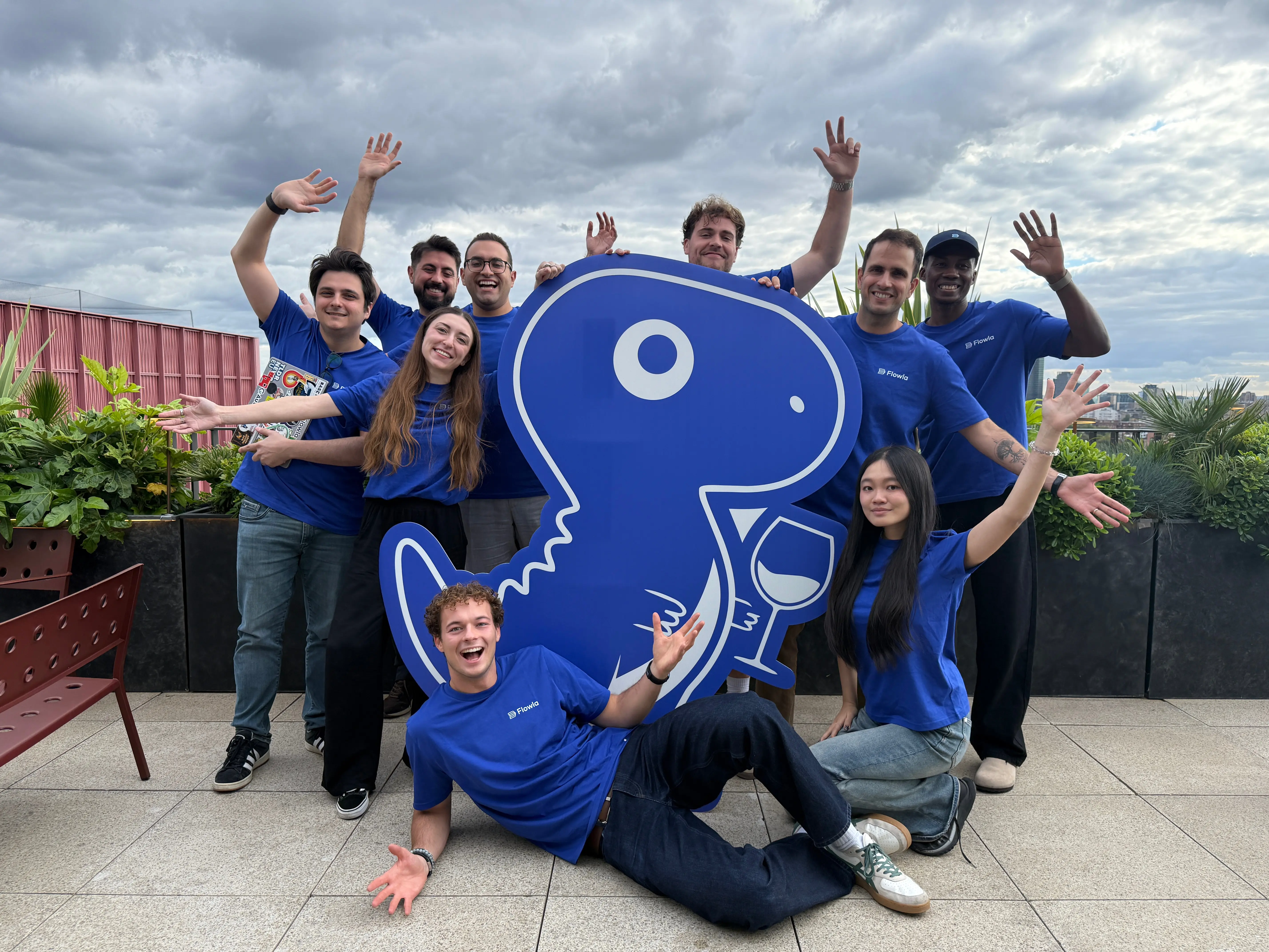 The Flowla team in London with the REX cardboard cutout, the revenue execution agent behind the player-coach launch.