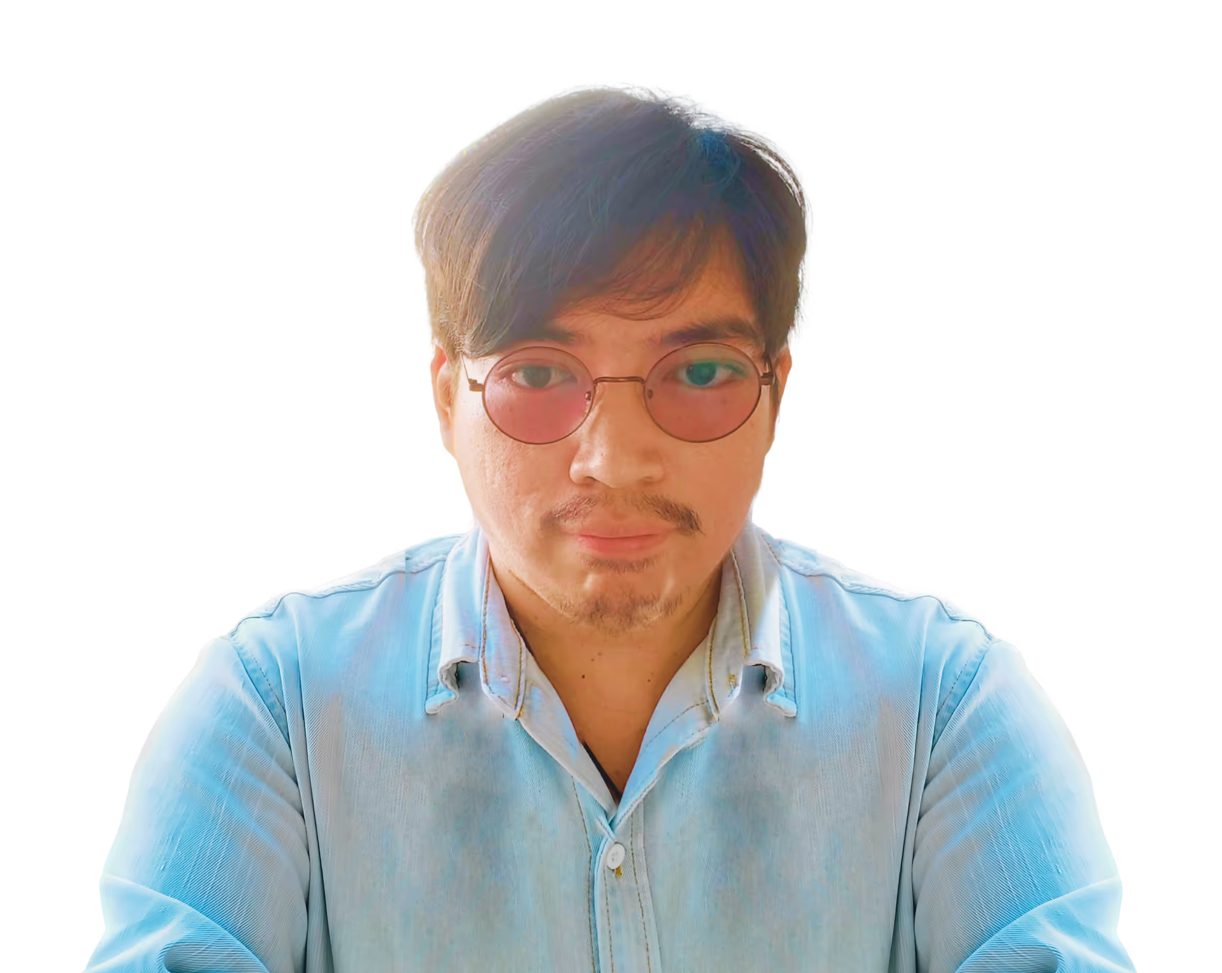 A webflow developer wearing a blue denim polo and eyeglasses