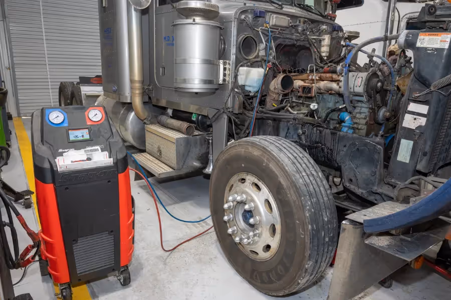 Diesel mechanic performing HVAC Systems repair on semi truck in Jackson, GA