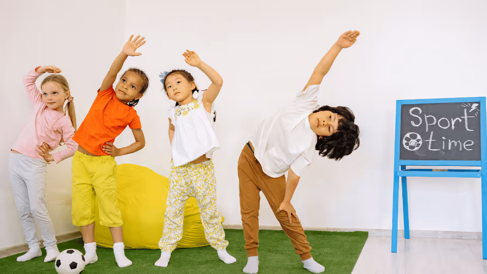 Children engaging in various sports activities in a classroom, showcasing their physical abilities and teamwork skills.