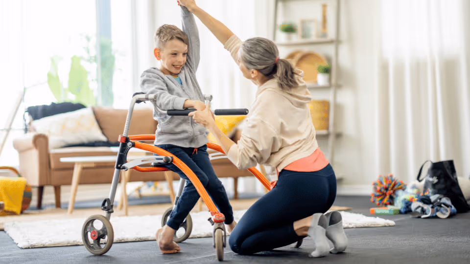 A woman assists a child in a wheelchair, showcasing the use of adaptive equipment for enhanced mobility and support.
