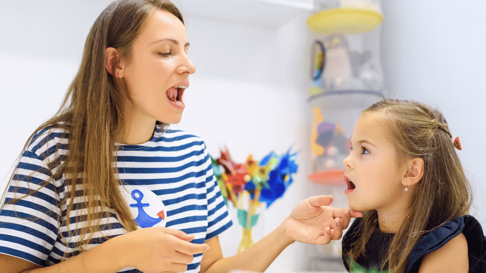 A woman and a little girl together during a speech language session, promoting healthy habits and communication