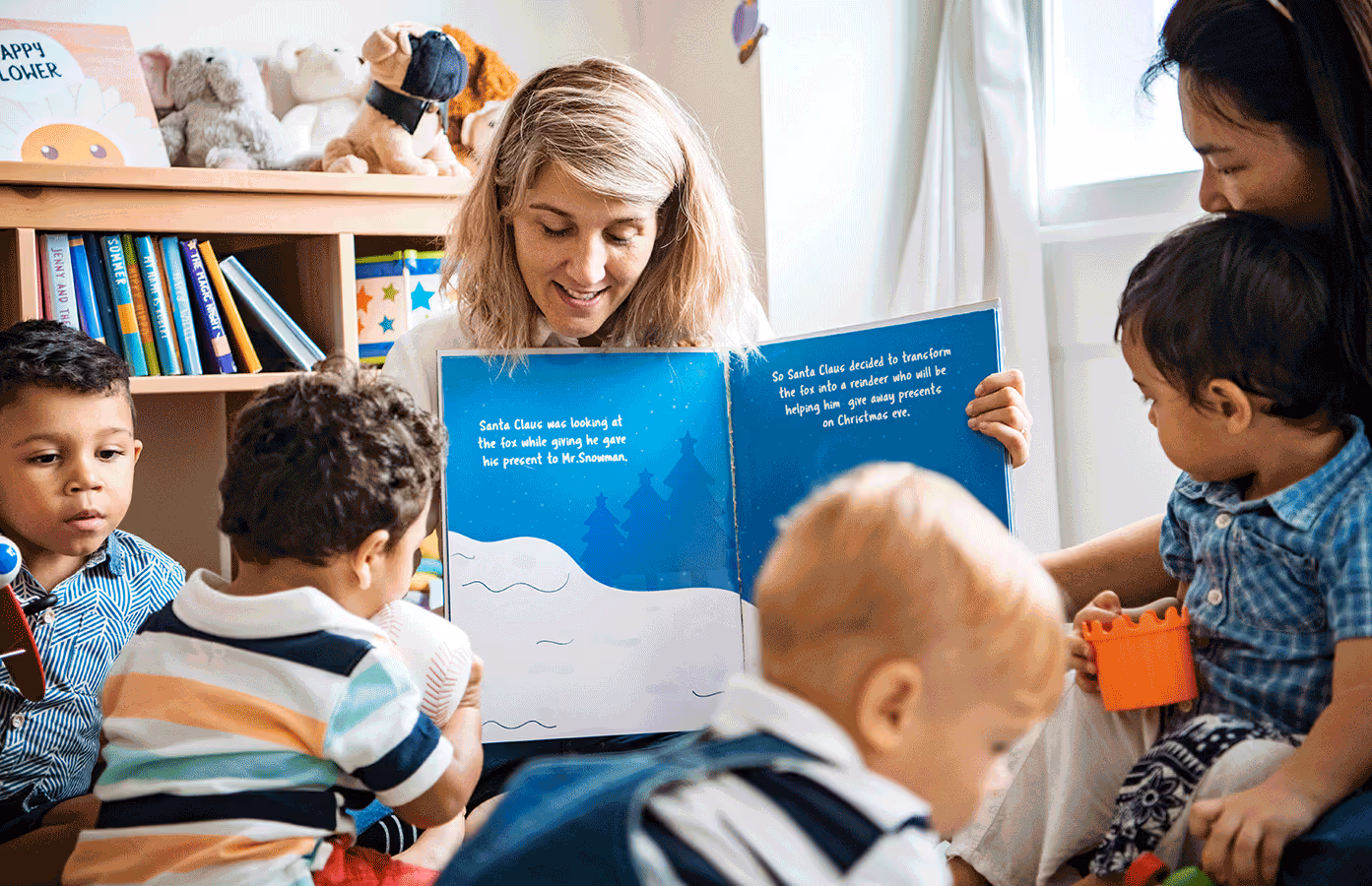 In a colorful classroom, a woman engages a group of children with an exciting story during group reading time.