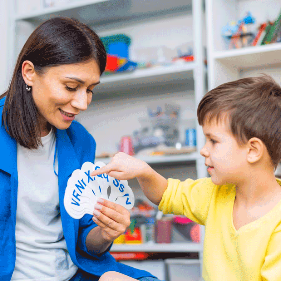 A therapist guides a child in a word game, emphasizing speech therapy techniques for pronouncing sounds clearly and effectively.