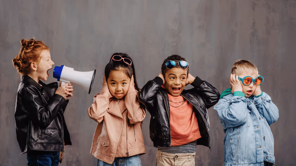 Four kids with megaphones and sunglasses, advocating for children's resources in Boston