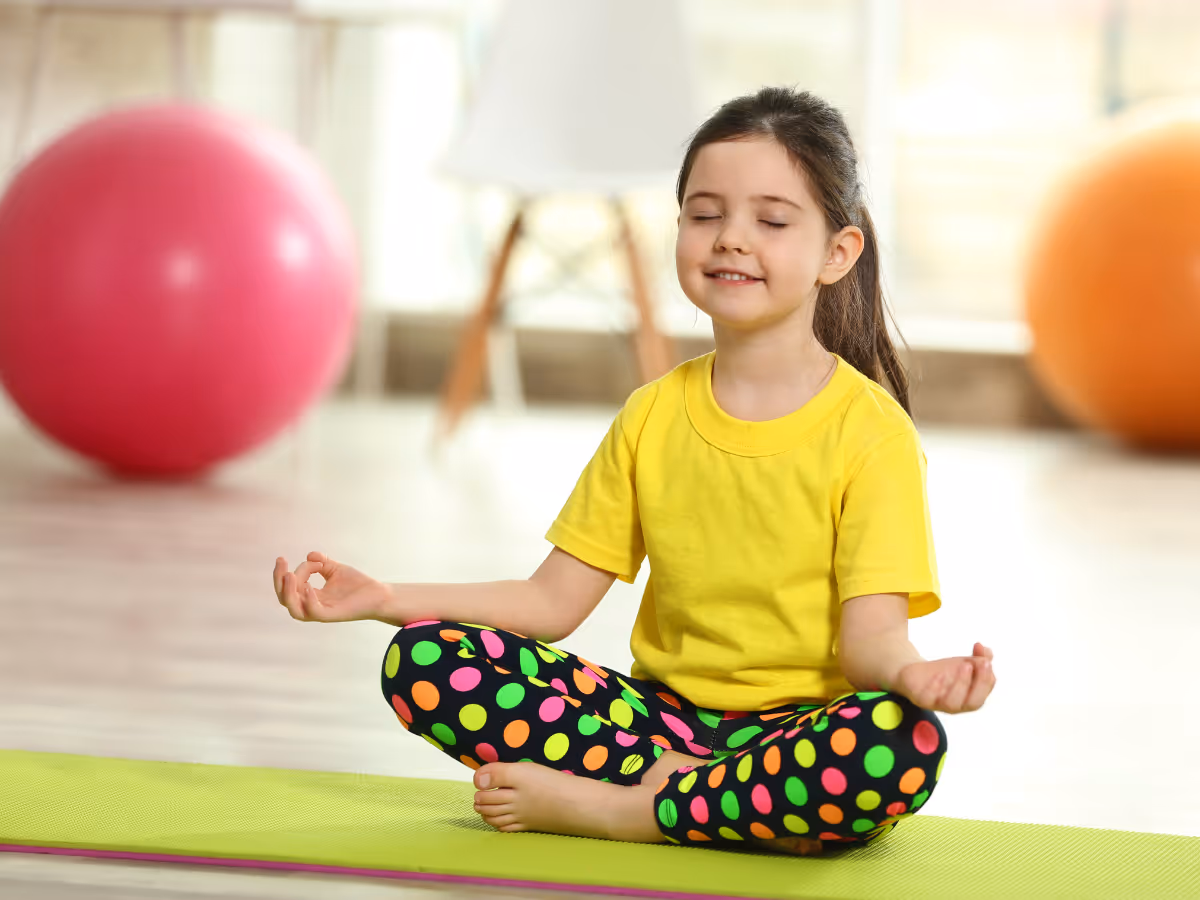 A girl in a yoga pose, engaged in meditation and mindfulness therapy, promoting calm and focus.