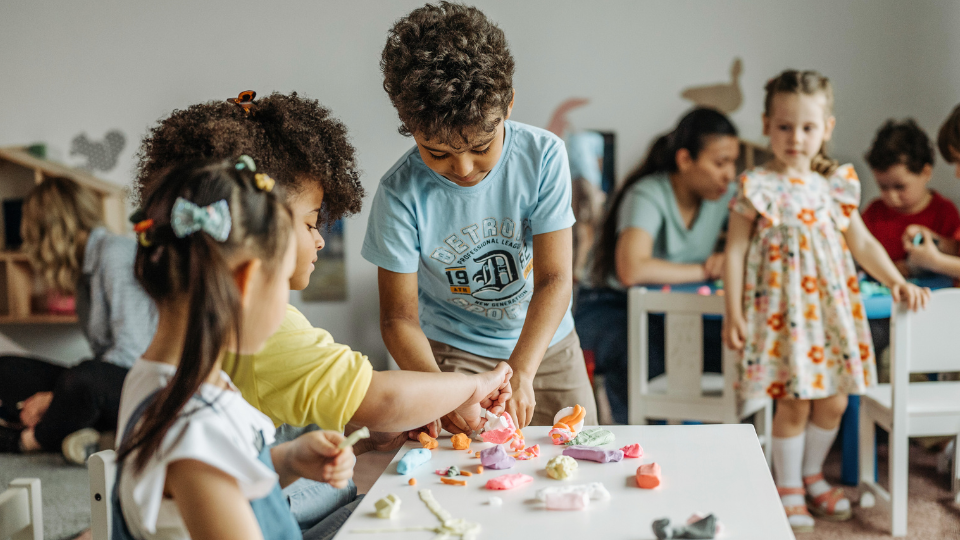 Children playing with colorful toys in a vibrant classroom, part of resources for kids in Houston