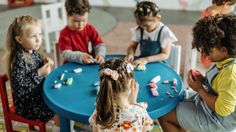 Children collaborate at a classroom table, highlighting family homework support resources near Houston, TX