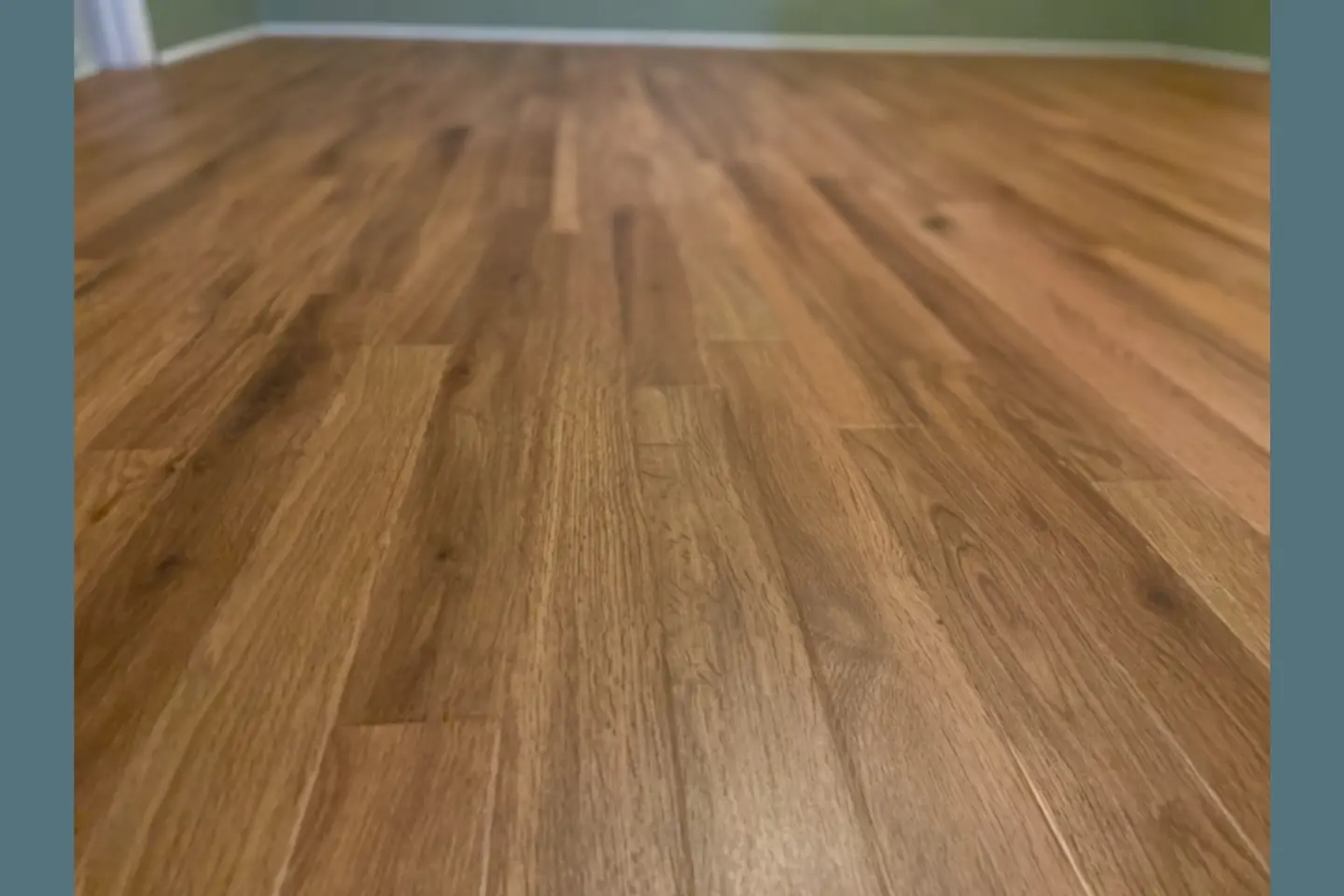 Wood look luxury vinyl plank installation in living room high-traffic area