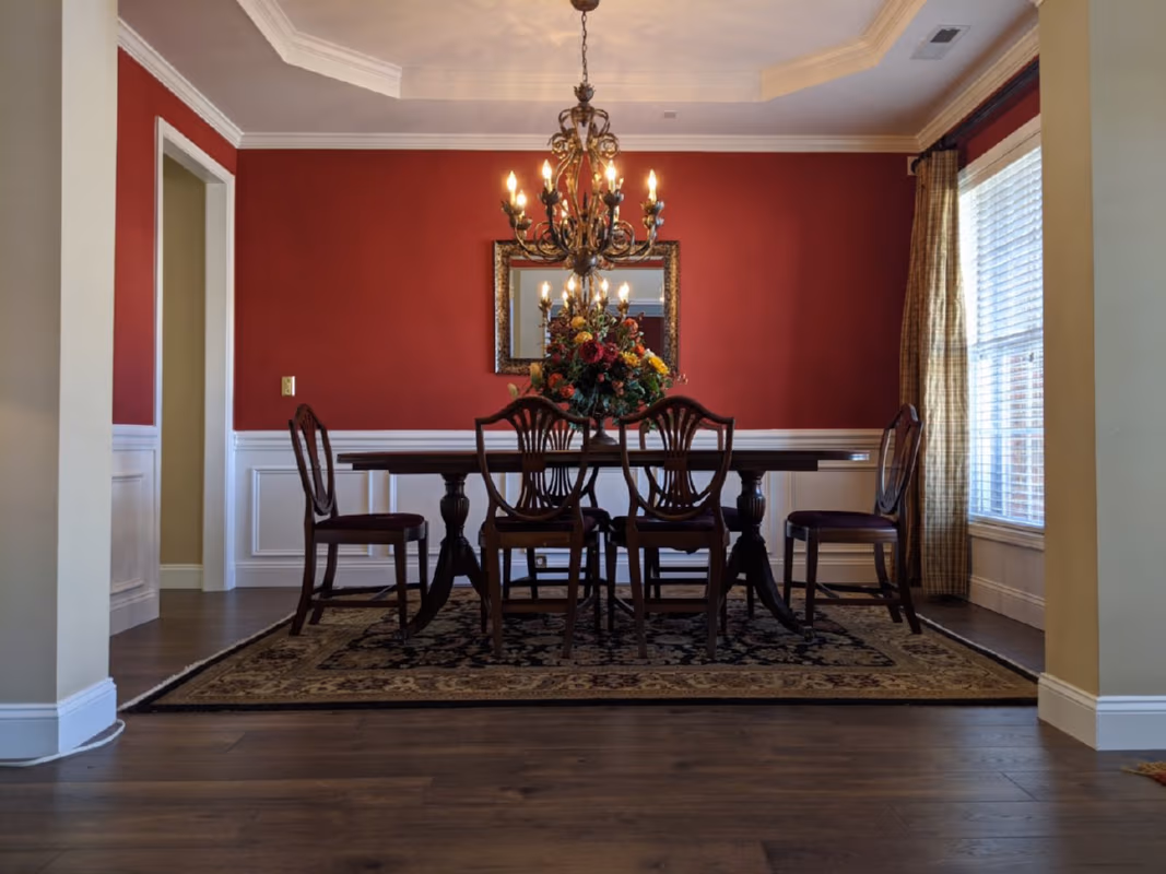 area rug in a dining room on top of hardwood floors