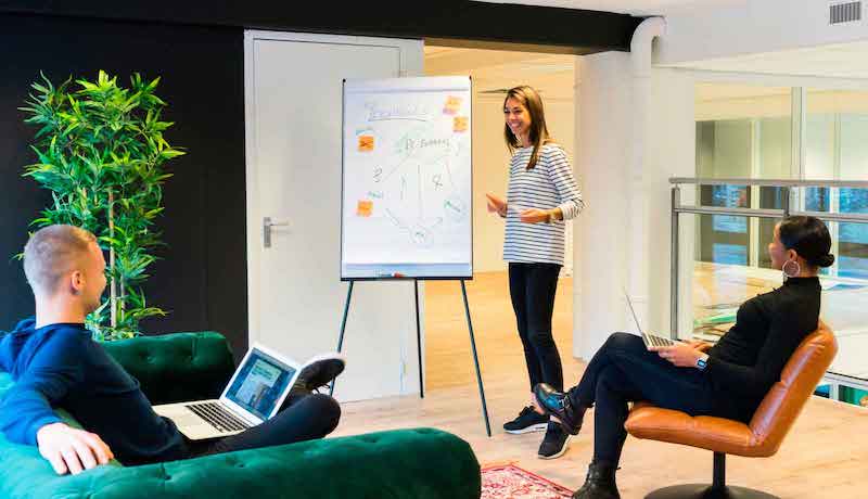 Woman presenting on a whiteboard