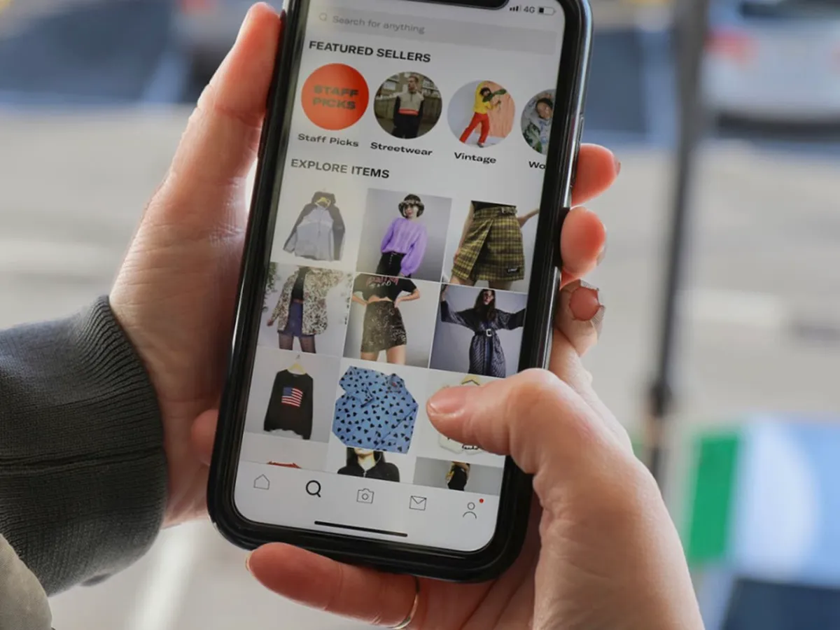 Person using online thrifting app on phone.