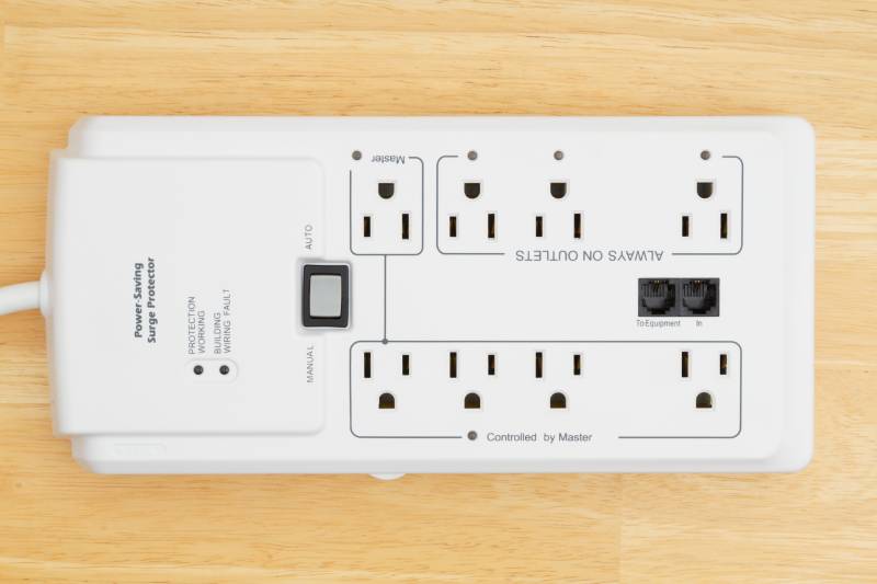White surge protector on wooden surface