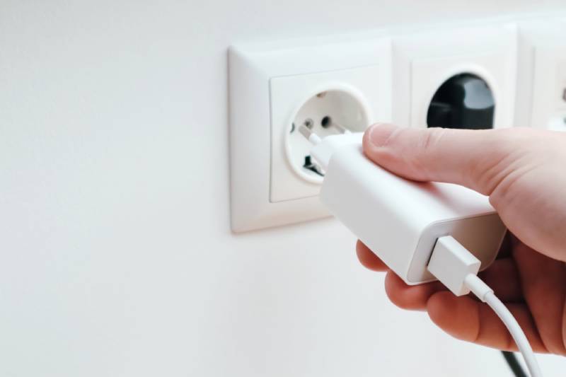 Plugging charger into outlet