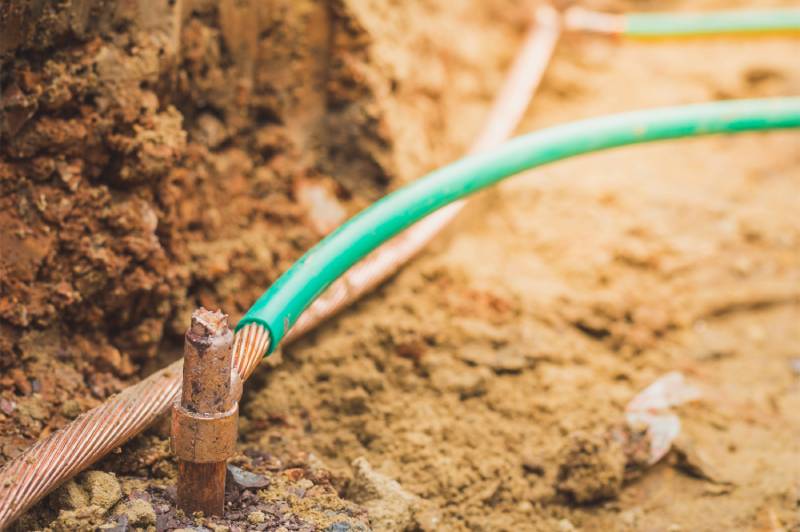 Rusty ground wire in soil