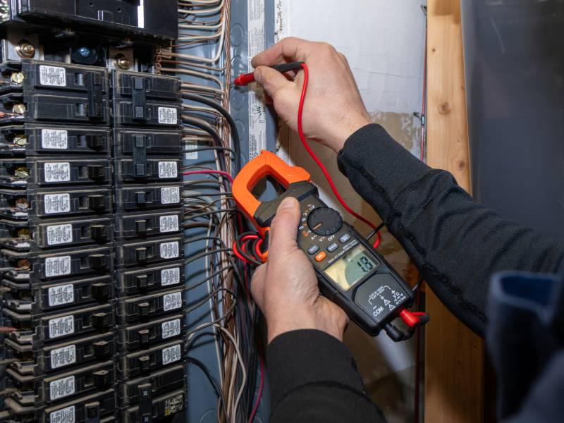 Electrician testing circuit panel