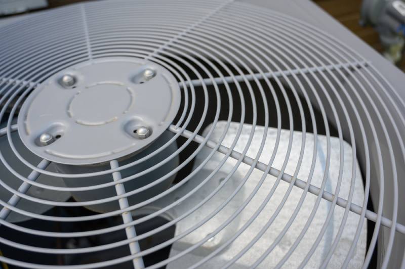 Close-up of a metal air conditioner fan cover.