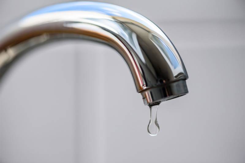 Dripping faucet close-up.