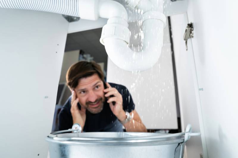 Man calling about leaking pipe under sink