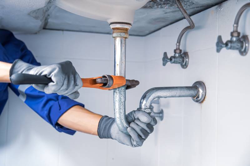 Plumber fixing noisy pipes
