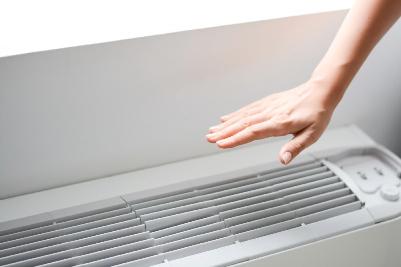 Hand above AC unit