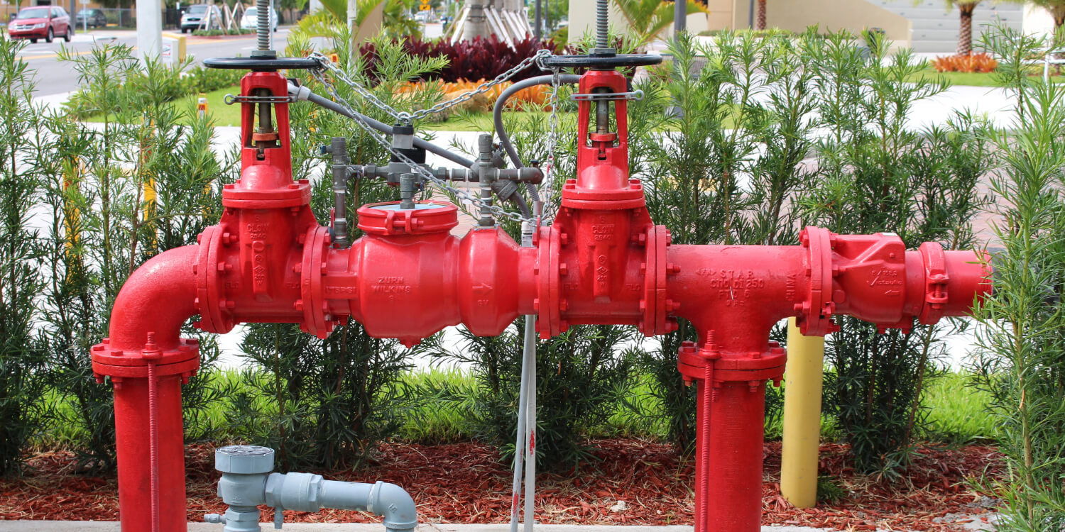 Red backflow preventer outdoors