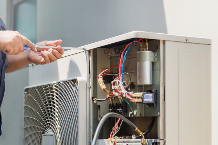 Technician fixing HVAC unit