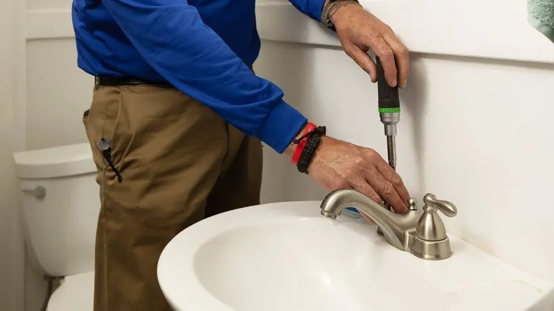 Plumber fixing bathroom sink, Albuquerque