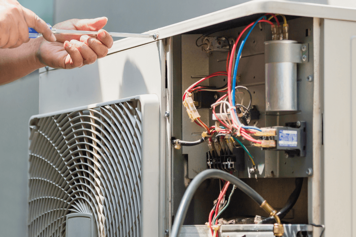 Technician repairing AC unit