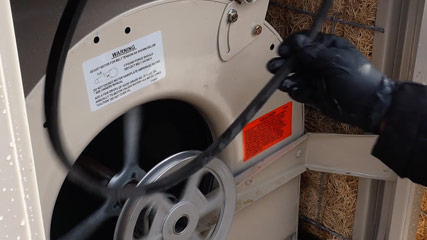 Technician repairs swamp cooler in Belen, NM.