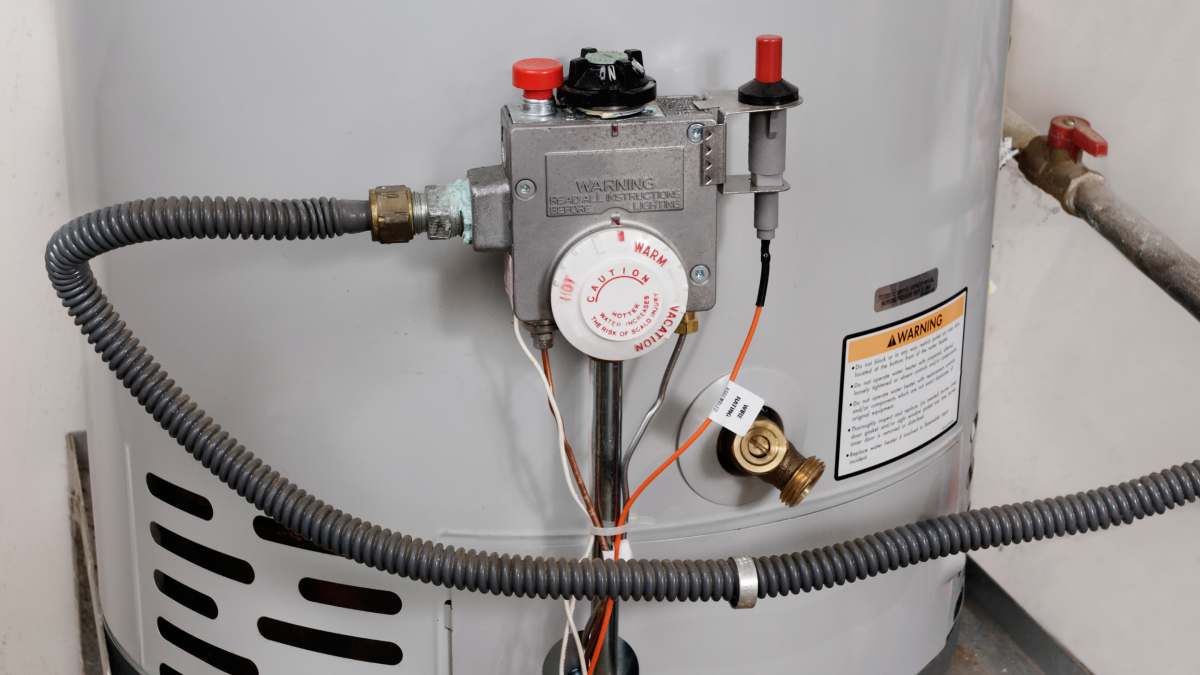 Water heater tank with pipes and control valve.