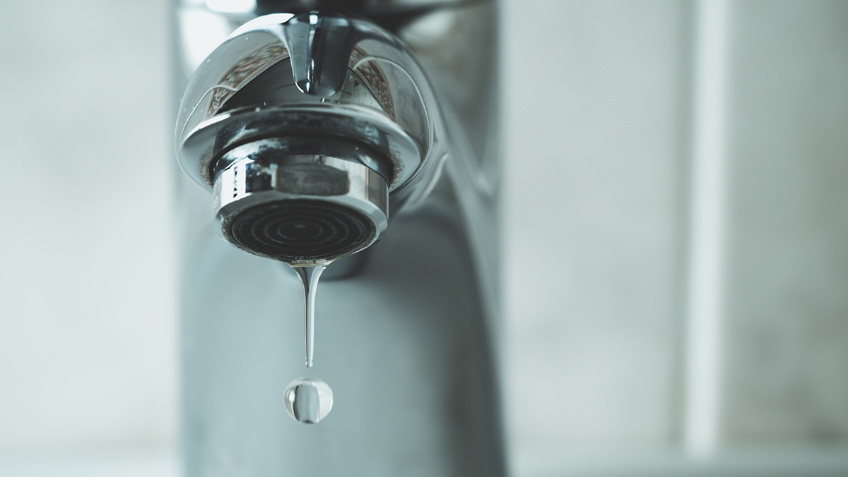 Chrome faucet dripping water