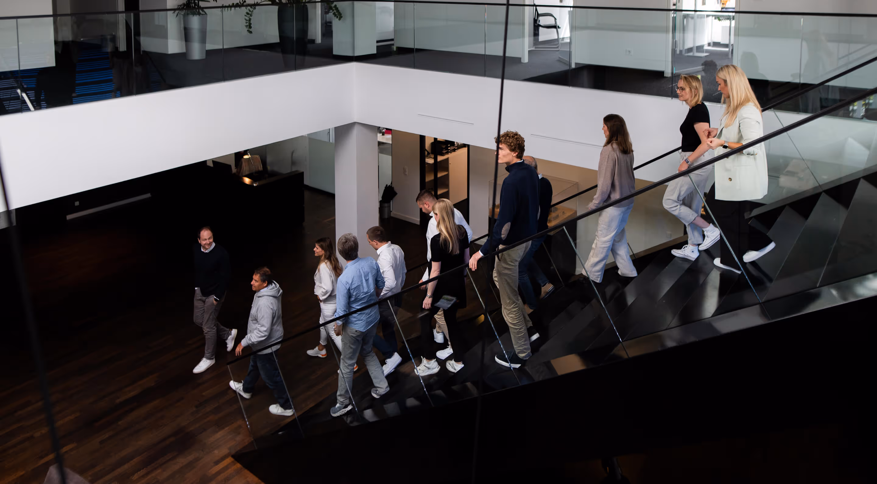 Office of Cusp Capital with the whole team walking down the stairs
