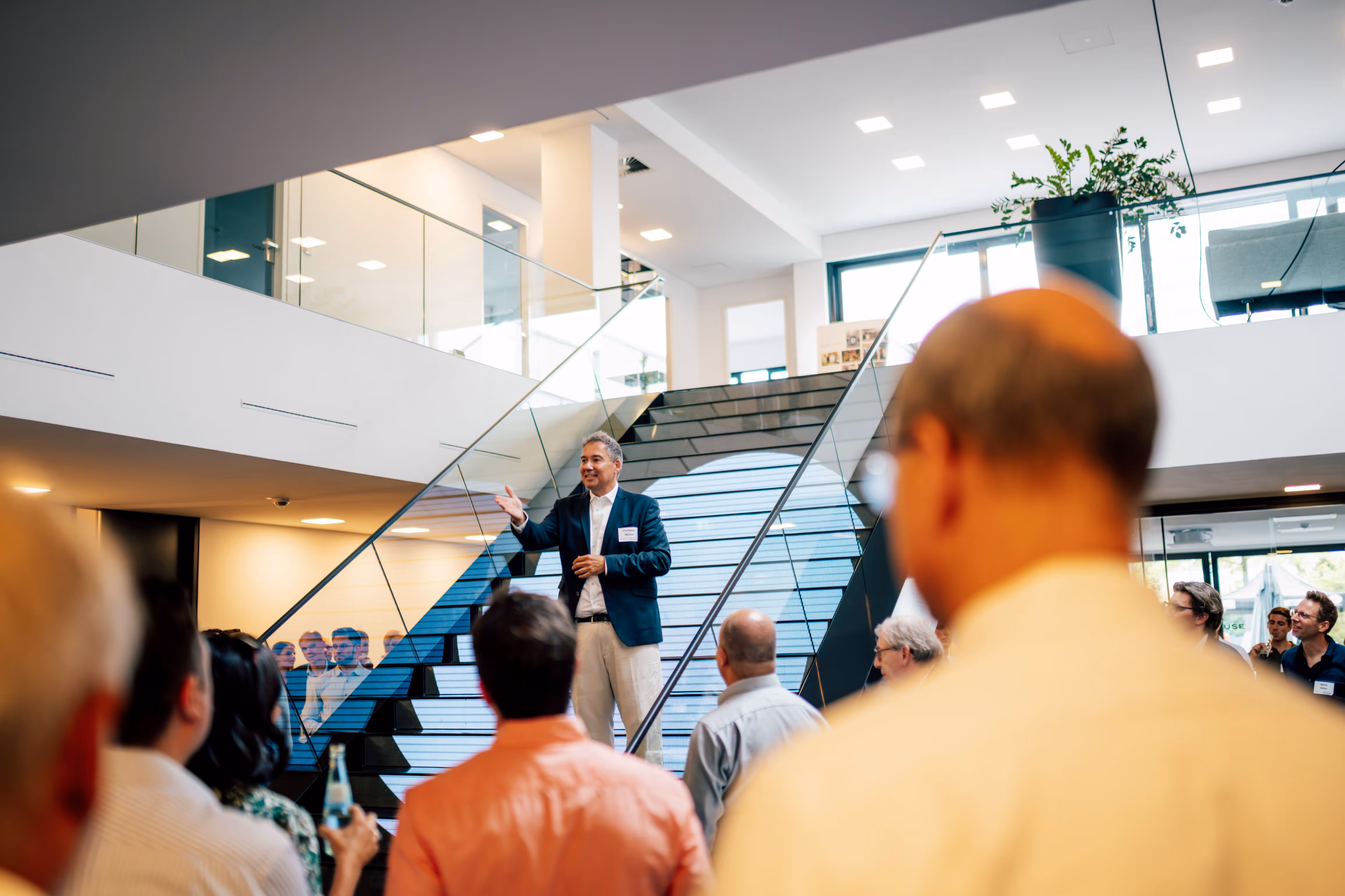 Cusp Capital Office with crowd listening to speaker on the stairs