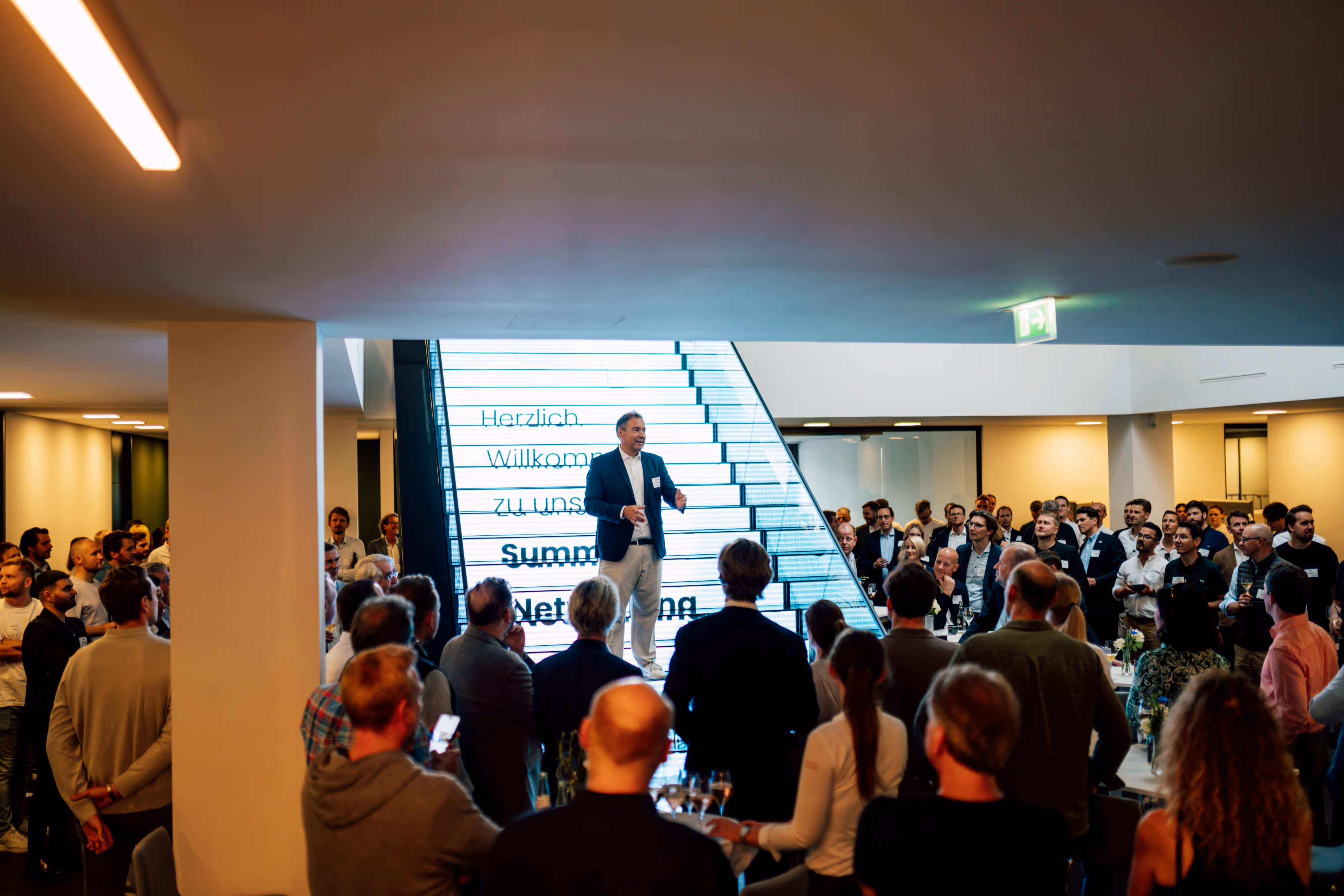 Cusp Capital Office with crowd listening to speaker on the stairs